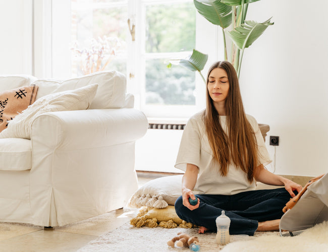 woman doing breathwork exercises in living room