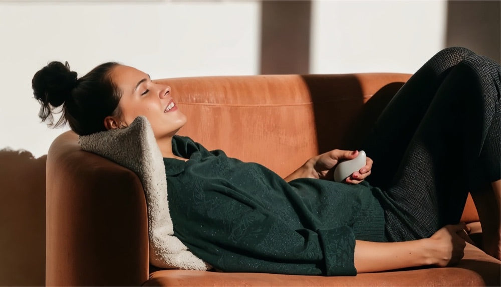 Someone relaxing on a sofa with a moonbird in one hand